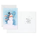 Greeting card with a snowman design and winter scenery on a white background