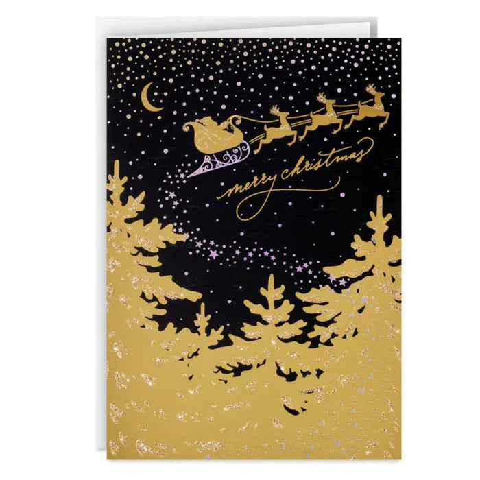 Christmas card with gold silhouette of Santa's sleigh and reindeer against a black night sky with gold trees.