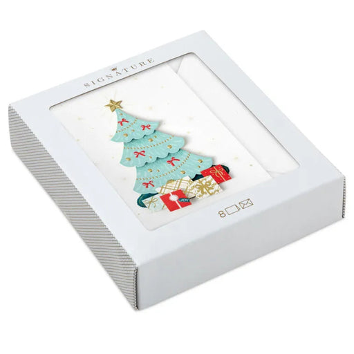 White box with a Christmas-themed card featuring a tree and presents on a white background