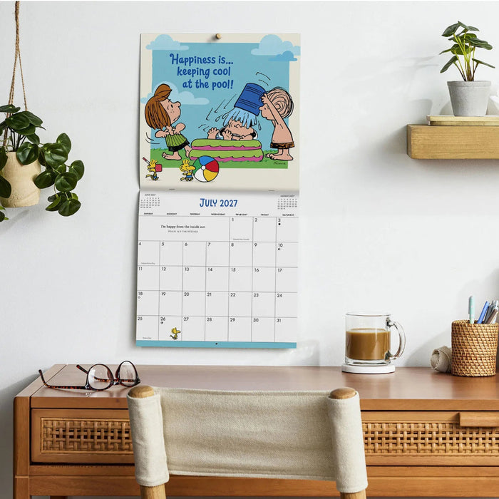 Hallmark Peanuts Happiness and Fun 2027 Inspirational 12-Month Wall Calendar featuring cheerful Peanuts artwork and a spacious monthly date grid.