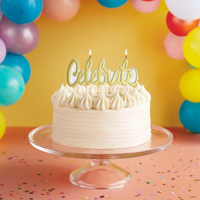 White cake with 'Celebrate' topper and colorful balloons in the background
