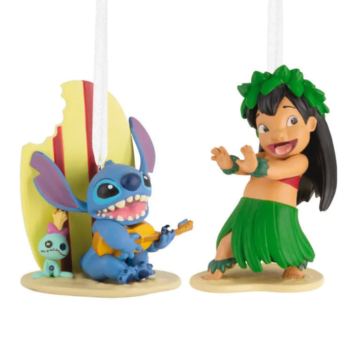 Two Disney Lilo and Stitch ornaments,  one blue character and one in a green hula outfit, on a white background. 