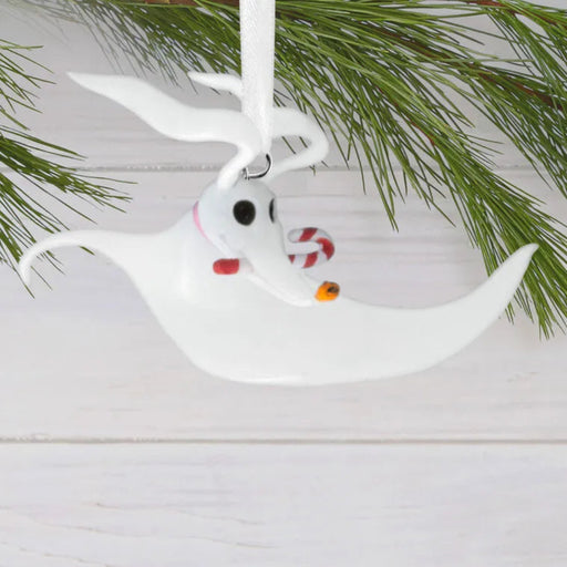 White Zero Ghost Dog ornament with a candy cane hanging on a Christmas tree.