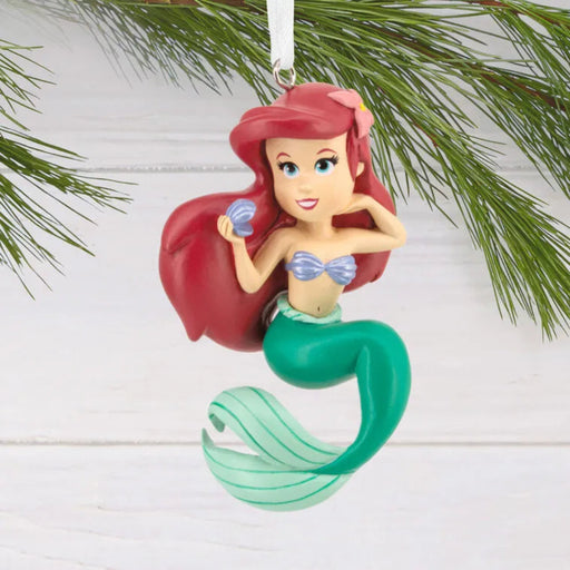 Mermaid ornament with red hair and green tail on a white background