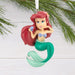 Mermaid ornament with red hair and green tail on a white background