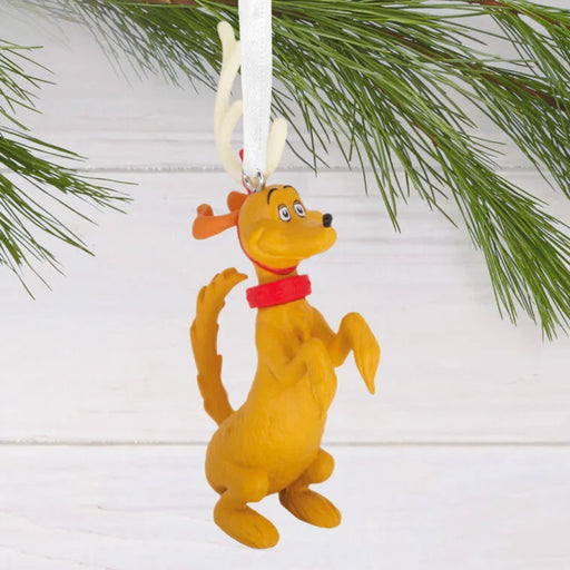 Max the Dog Christmas ornament with red collar hanging on a branch