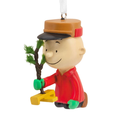 Christmas ornament of a character holding a tree on a white background