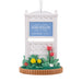 Decorative ornament with 'Stars Hollow' sign and flowers on a white background