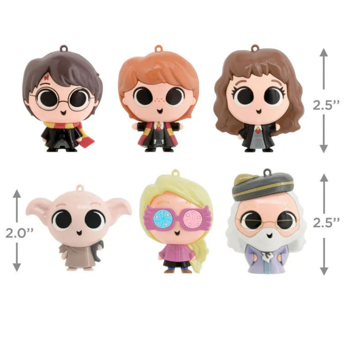 One  chosen at random of six Harry Potter-themed figurine ornaments   with measurements on a white background