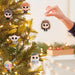 One of six chosen at random Harry Potter mystery ornaments on a Christmas tree with a blurred indoor background