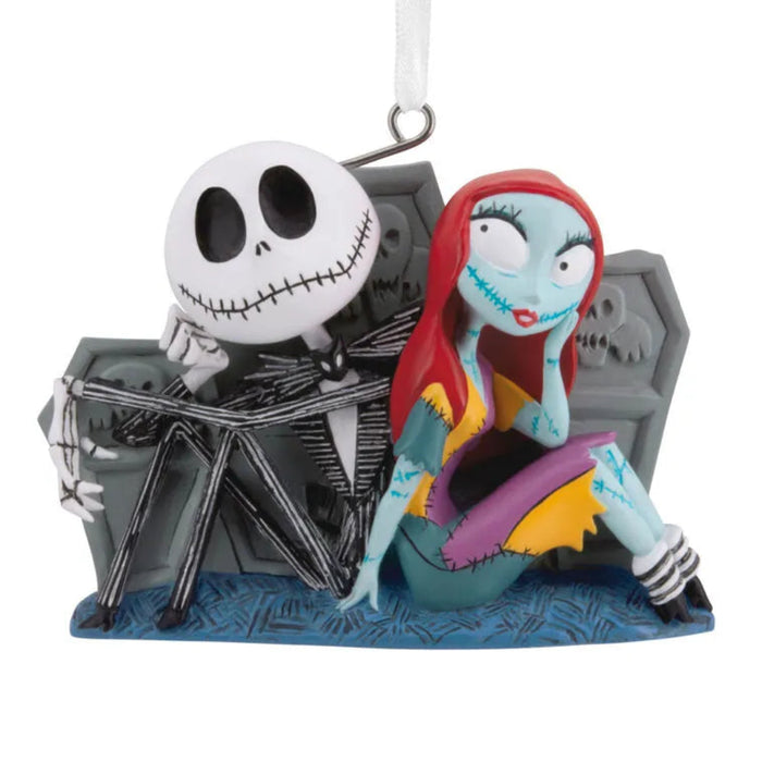  Disney Ornament featuring Jack and Sally skeleton couple sitting by tombstones  with a white background