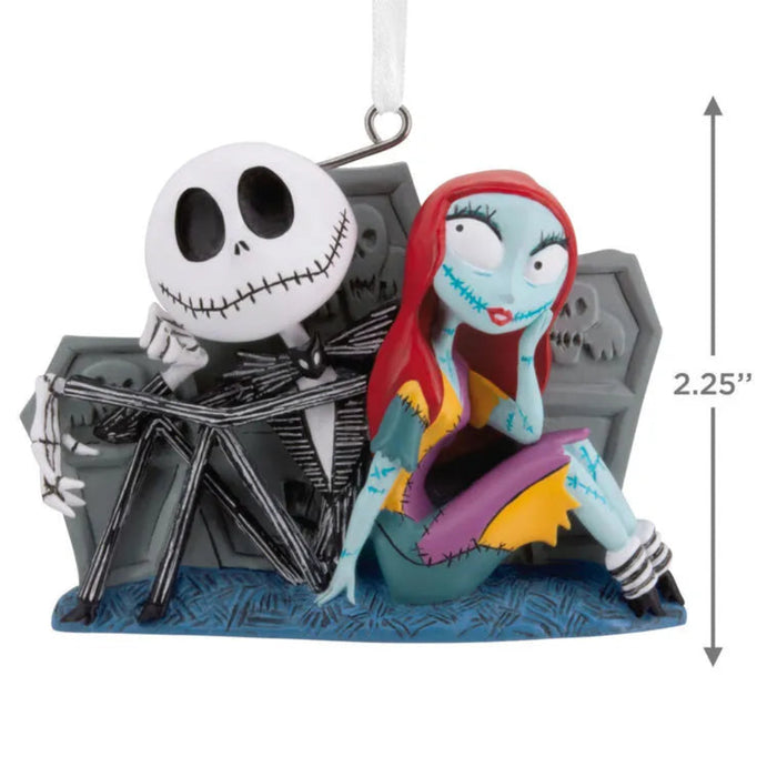  Disney Decorative Jack and Sally ornament the skeleton couple sitting together by tombstones  with dimensions indicated on a white background. 