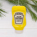 Heinz Yellow Mustard bottle ornament on a white background with greenery