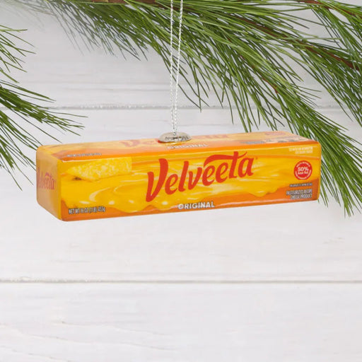 Velveeta cheese box ornament hanging on a branch