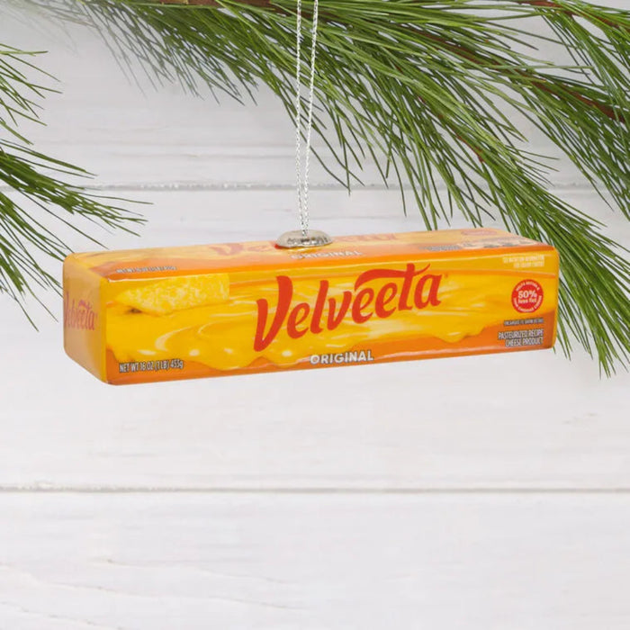 Velveeta cheese box ornament hanging on a branch