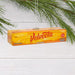Velveeta cheese box ornament hanging on a branch