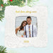 Decorative photo ornament with a couple's picture and 'Best love story ever' text, surrounded by Christmas tree branches.