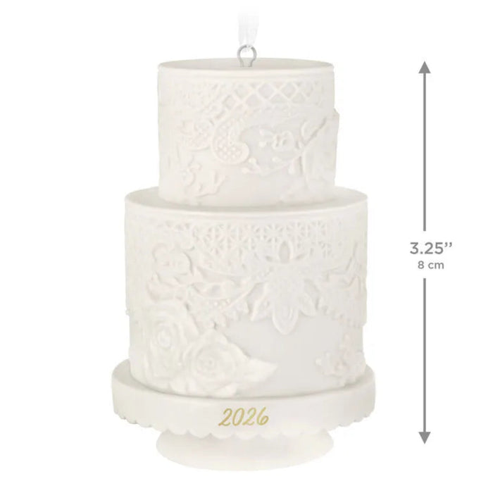 Two-tiered white decorative cake ornament with '2026' on a white background