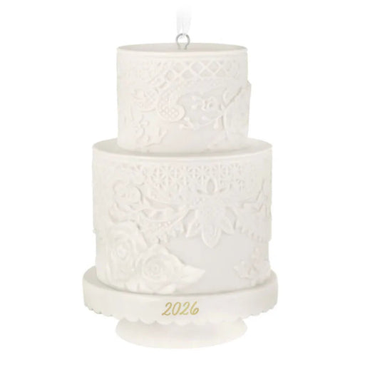 Two-tiered white embossed candle with '2026' on a white background
