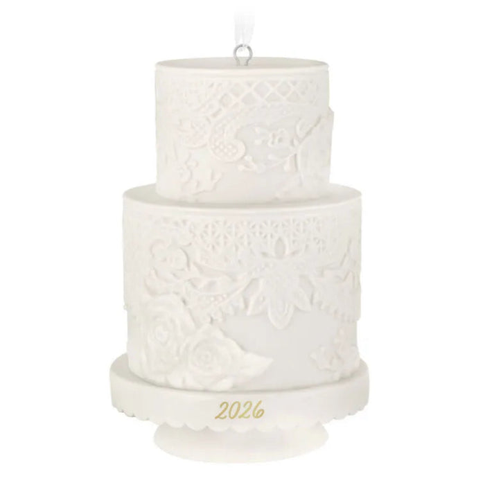 Two-tiered white embossed candle with '2026' on a white background