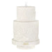 Two-tiered white embossed candle with '2026' on a white background