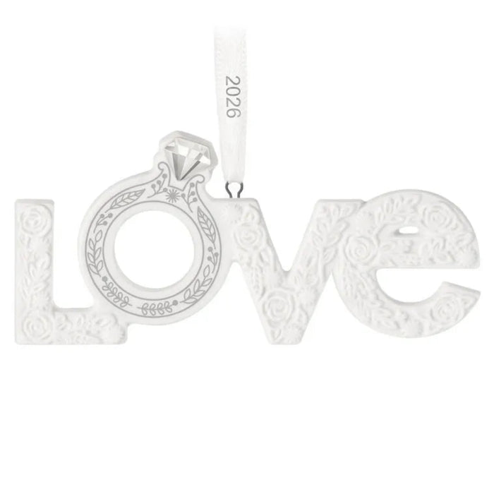 Silver 'LOVE' ornament with intricate designs on a white background