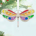 Colorful butterfly-shaped ornament hanging on a Christmas tree.
