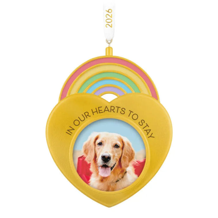 Heart-shaped ornament with a dog photo and 'In Our Hearts to Stay' text, hanging on a Christmas tree.