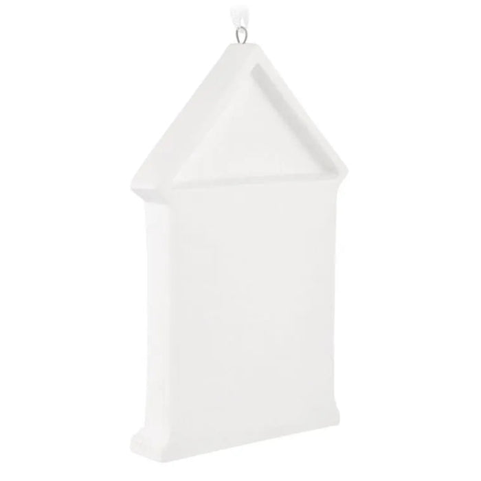 White decorative item resembling a birdhouse on a white background