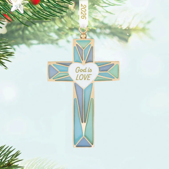 Decorative cross ornament with 'God is Love' text on a light blue background