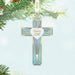 Decorative cross ornament with 'God is Love' text on a light blue background