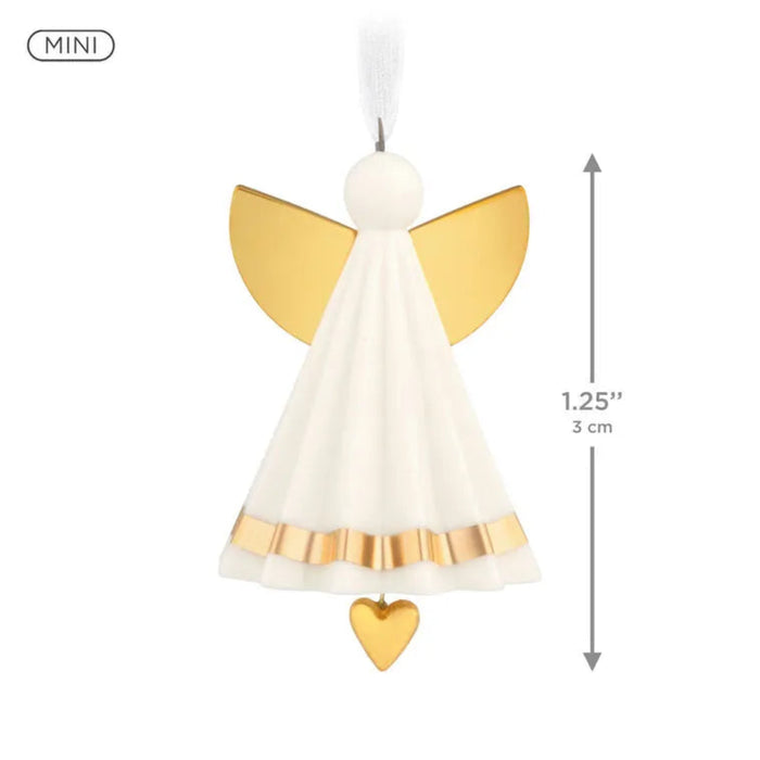 Miniature angel ornament with gold wings and a heart on a white background