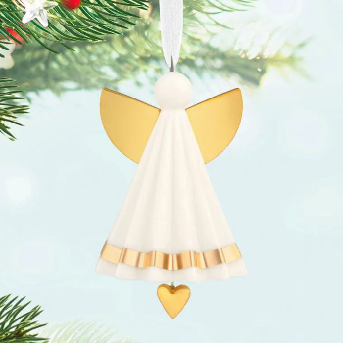  Hallmark Keepsake Angel ornament with gold wings and a heart, hanging from a Christmas tree.