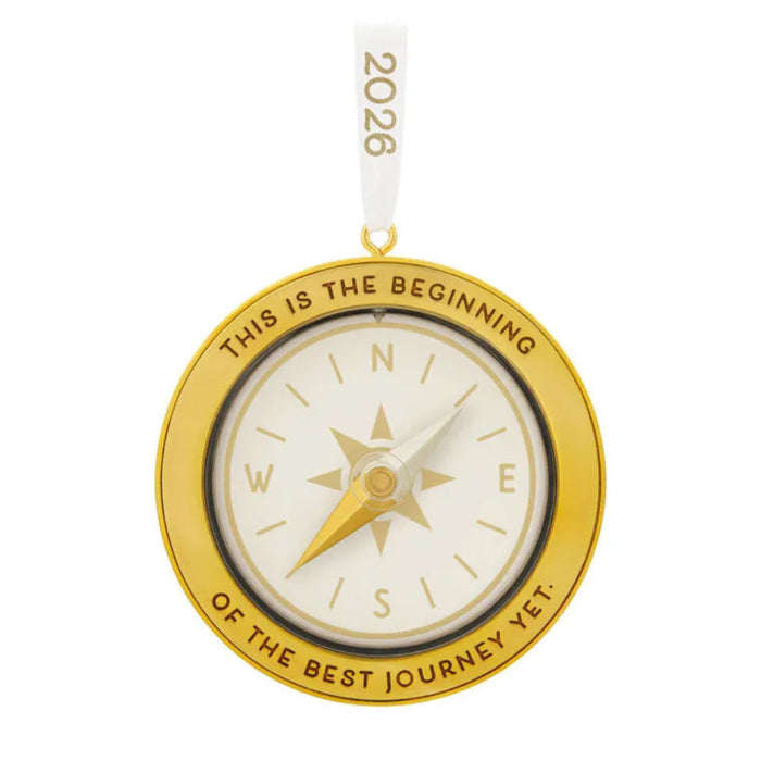 Gold compass ornament with 'This is the beginning of the best journey yet' text on a white background