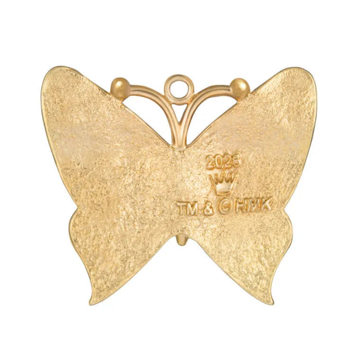 Gold butterfly pendant with '2026' and 'TM & HMK' engraving on a white background