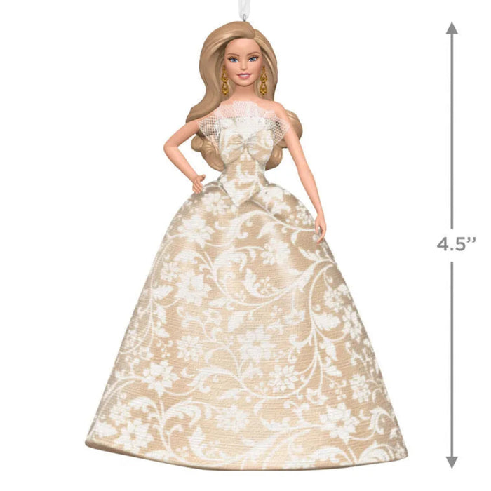 Barbie doll in a gold and white dress with a measurement label on a white background