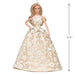 Barbie doll in a gold and white dress with a measurement label on a white background