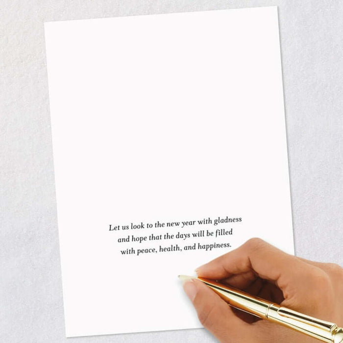 Handwritten message on a card with a gold pen, on a light gray background