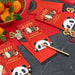 Red envelopes with panda designs and 'Happy 2026' text on a dark surface with oranges and gold coins.