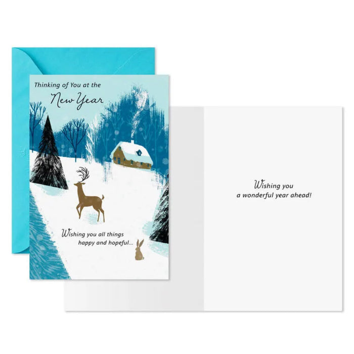 Greeting card with winter scene and deer, blue envelope, and text on a white background