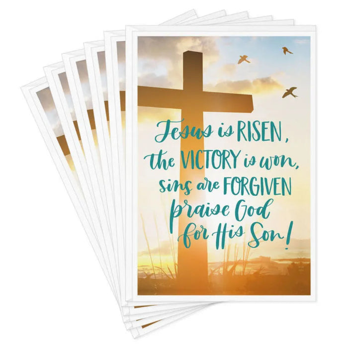 Stack of greeting cards with a cross and Easter message on a white background