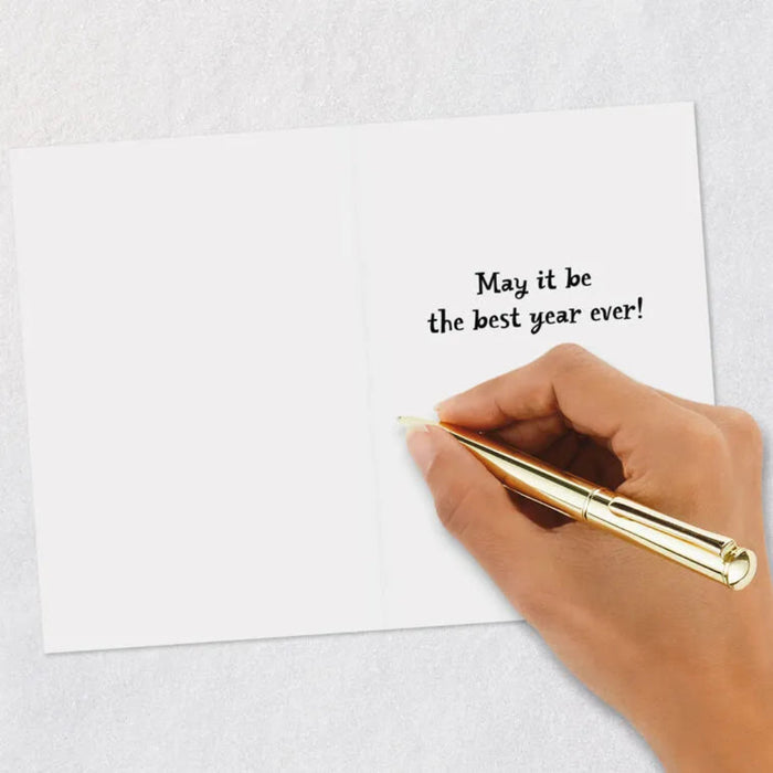 Hand holding a gold pen over a white card with text on a light gray background