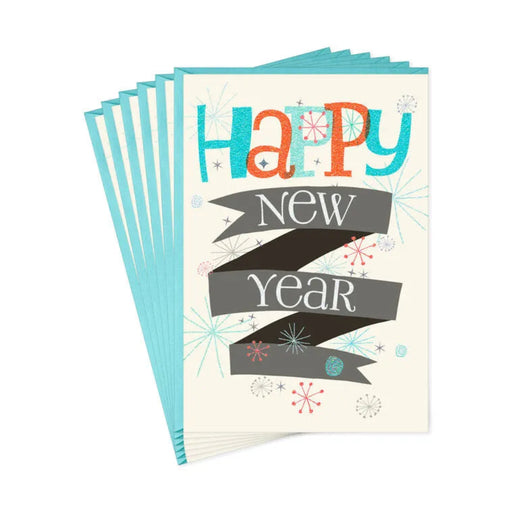Stack of greeting cards with 'Happy New Year' text on a white background