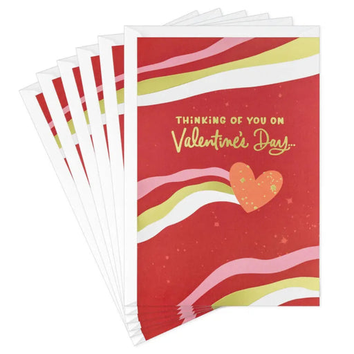 Pack of Valentine's Day cards with colorful pink, gold and white  design and text on a white background