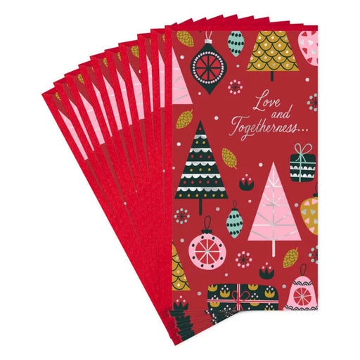 Stack of red Christmas-themed cards with festive designs on a white background