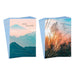 Two stacks of greeting cards with nature-themed designs on a white background