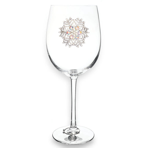 Clear wine glass with decorative emblem on a white background