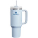 Light blue Stanley mug with handle and straw on a white background
