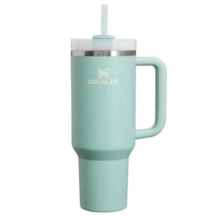 Mint green Stanley mug with handle and straw on a white background