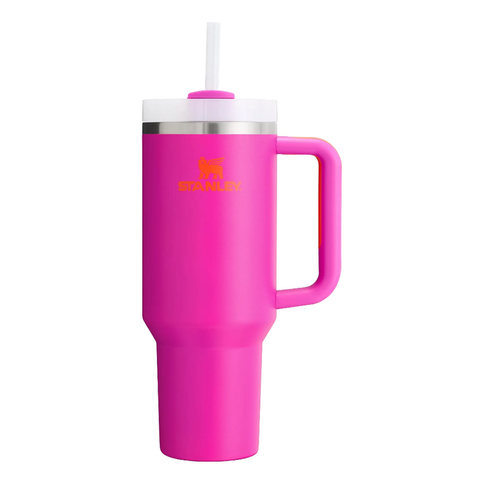 Pink Stanley tumbler with a handle and straw on a white background